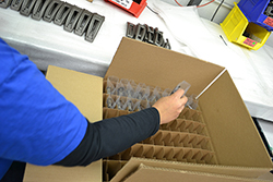Packaging and Assembly, placing parts in plastic wrappers and then in a cardboard box